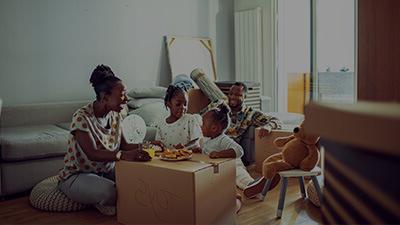family sitting around a cardboard box